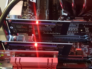 Photo of a part of the motherboard with 2 PCIe NVMe adapters populated with SSD.