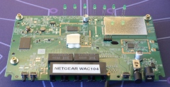 Photo of a NETGEAR WAC104 access point without the casing.